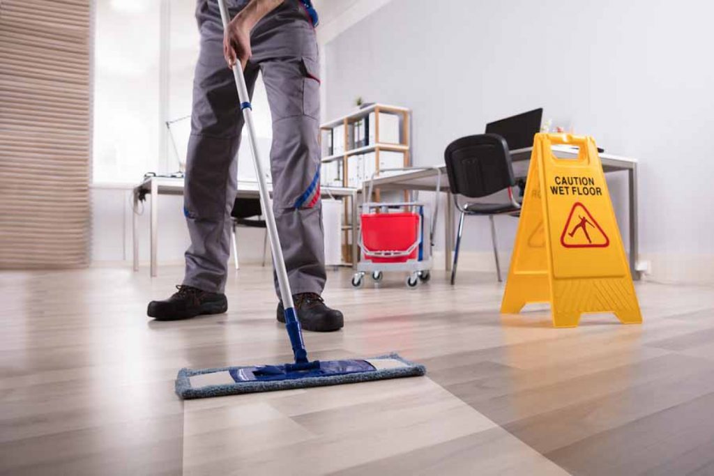 Commercial cleaner cleaning floor of office building
