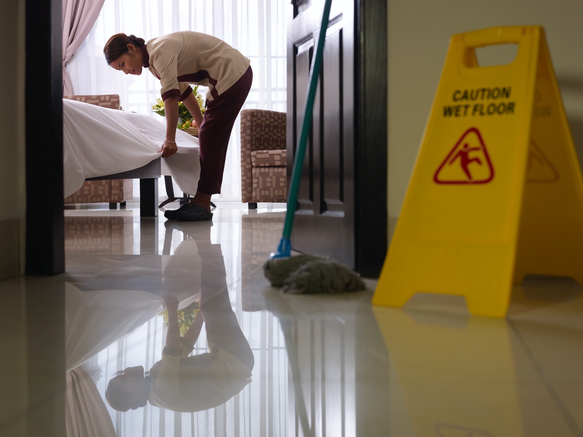 maid-at-work-and-cleaning-in-luxury-hotel-room
